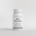 Supplement bottle labeled 'Zinc Glycinate' by Walrus Core on a light gray background